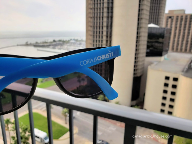 Corpus Christi sunglasses on balcony of Omni Hotel